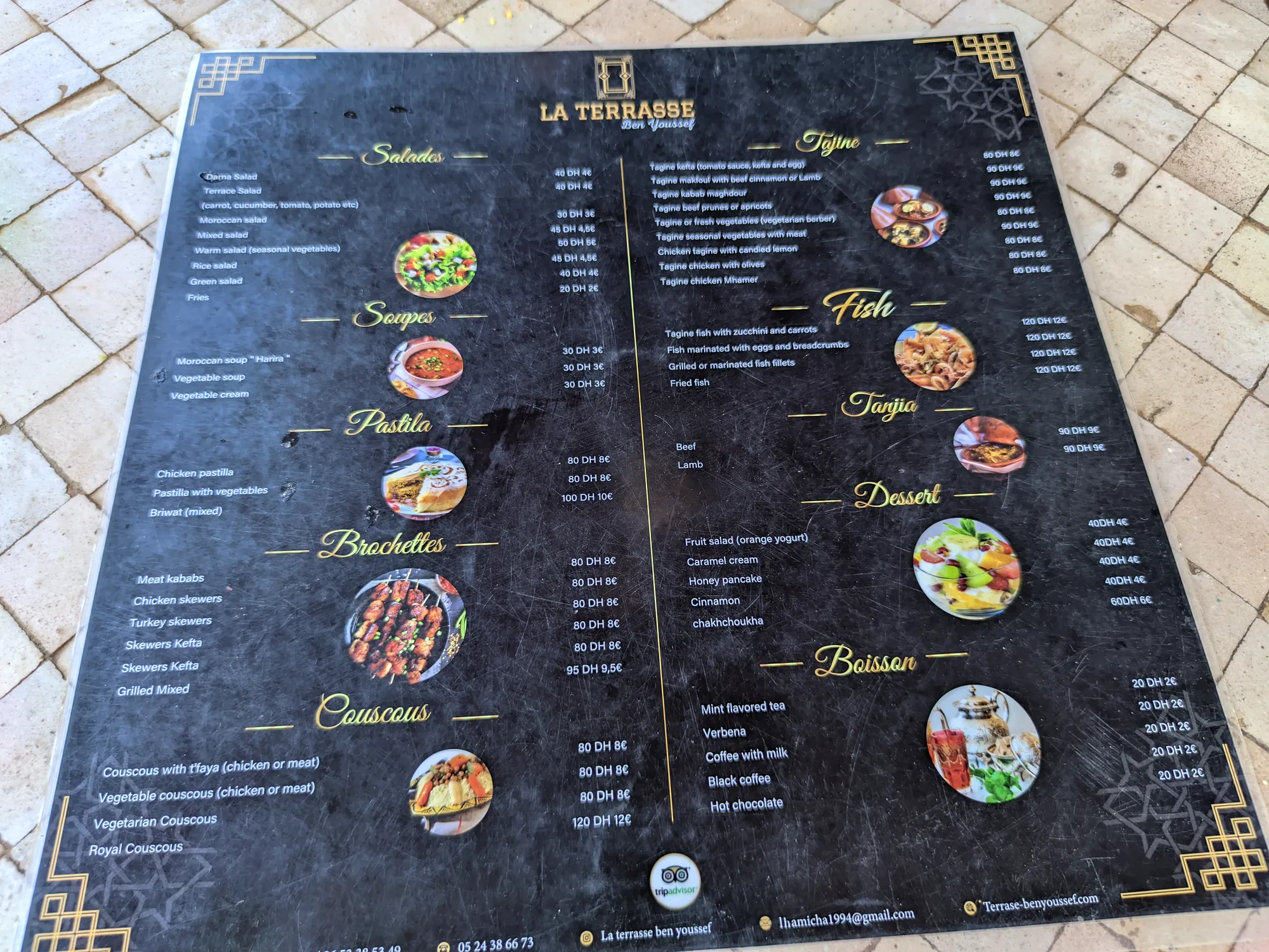 The menu board at the restaurant entrance: dishes and prices in dirhams and euros