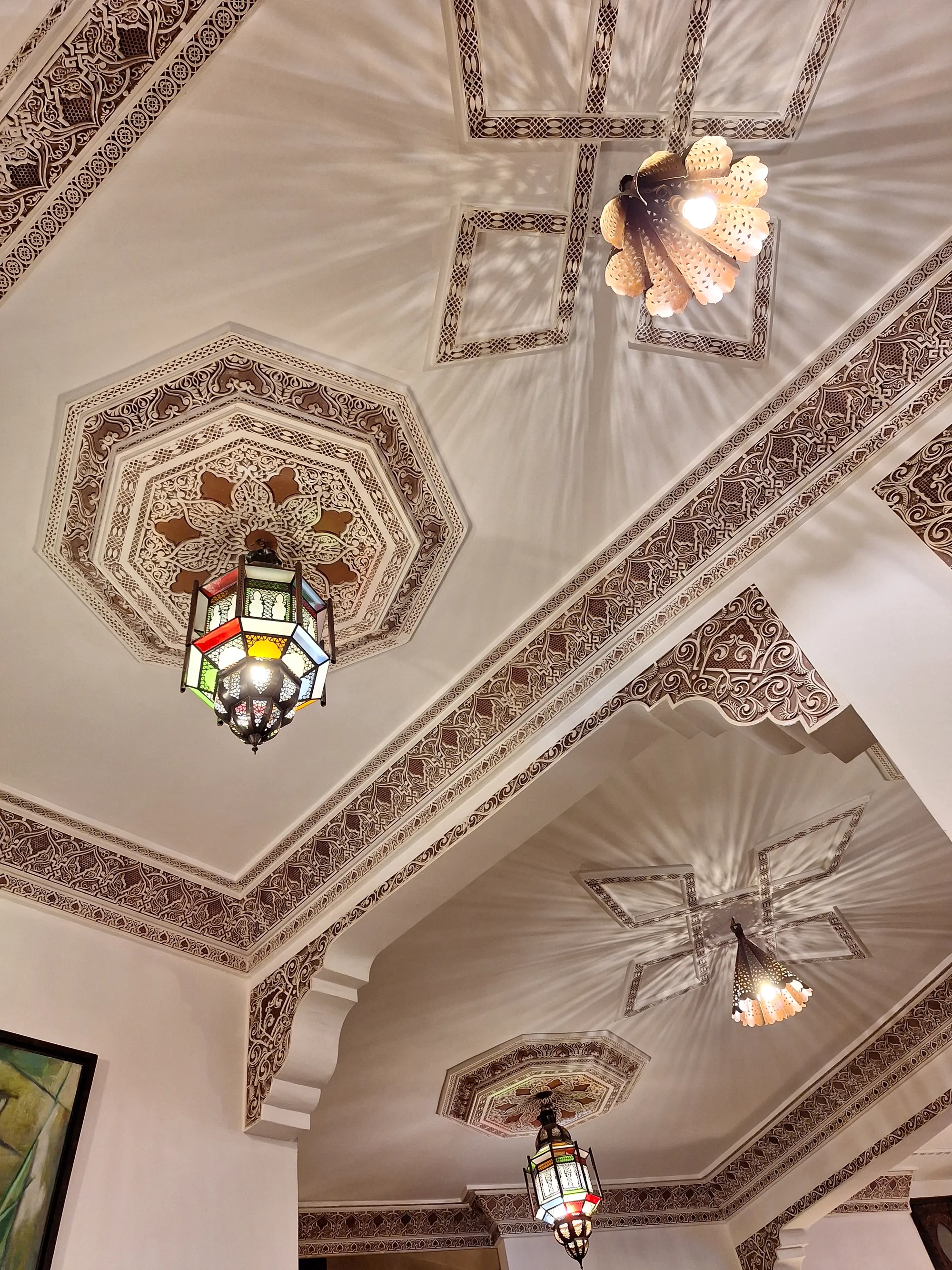 Carved and painted cedar ceiling above one of the salons